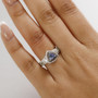 unheated tanzanite tsavorite brown and white zircon trillion halo ring in rhodium over sterling silver worn on a hand