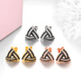 close up of black spinel and white zircon triangle stud earrings in 925 sterling silver