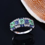 multi color lab grown sapphire cluster rhodium over sterling silver band ring shown in a lifestyle photo
