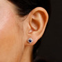 blue kyanite and white zircon rhodium over sterling silver halo stud earrings worn on the ear