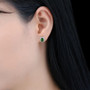 close up of emerald cut chrome diopside and white zircon halo stud earrings in rhodium over sterling silver