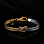 love knot bracelet in 18k yellow gold and rhodium over sterling silver shown in a lifestyle photo