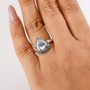 aquamarine champagne and white diamond halo ring in rhodium over sterling silver worn on a hand