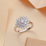 round moissanite cluster ring in rhodium over sterling silver shown in a lifestyle photo