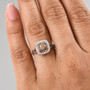 champagne and white diamond 18k rose gold over sterling silver double halo ring worn on a hand