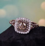 champagne and white diamond 18k rose gold over sterling silver double halo ring shown in a lifestyle photo