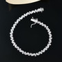 white zircon tapered baguette tennis bracelet in rhodium over sterling silver shown in a lifestyle photo
