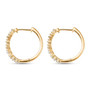 side view of white zircon tapered baguette hoop earrings in 18k yellow gold over sterling silver