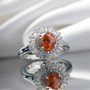 sphalerite and moissanite round halo rhodium over sterling silver ring shown in a lifestyle photo