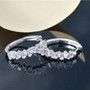 white zircon tapered baguette hoop earrings in rhodium over sterling silver shown in a lifestyle photo