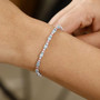 blue zircon pink sapphire and moissanite tennis bracelet in rhodium over sterling silver worn on a wrist
