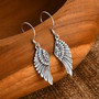 rhodium over sterling silver wing fishhook earrings shown in a lifestyle photo