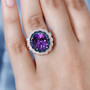 amethyst blue and white diamond double halo ring in 18k rose gold over sterling silver worn on a hand