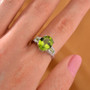 peridot and zircon rhodium over sterling silver ring worn on a hand