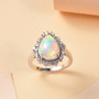 pear ethiopian opal and diamond halo rhodium over sterling silver ring shown in a lifestyle photo
