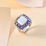 opal tanzanite and zircon halo ring in 18k yellow gold and rhodium over sterling silver shown in a lifestyle photo