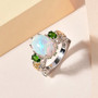 opal chrome diopside and zircon trilogy ring in 18k yellow gold and rhodium over sterling silver shown in a lifestyle photo