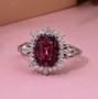 rubellite tourmaline and moissanite halo ring in rhodium over sterling silver shown in a lifestyle photo