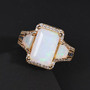 ethiopian opal ceylon sapphire and zircon three stone ring in 18k yellow gold over sterling silver shown in a lifestyle photo