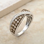 champagne and white diamond crossover band ring in rhodium over sterling silver shown in a lifestyle photo