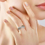 champagne and white diamond crossover band ring in rhodium over sterling silver worn on a hand