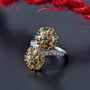 yellow zircon chrome diopside and white zircon floral cluster bypass ring in rhodium over sterling silver shown in a lifestyle photo