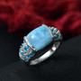 larimar neon apatite and white zircon halo ring in rhodium over sterling silver shown in a lifestyle photo