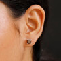 chocolate sapphire emerald cut stud earrings in rhodium over sterling silver worn on the ear