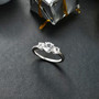 lab white sapphire round trilogy ring in rhodium over sterling silver shown in a lifestyle photo