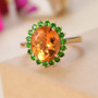 madeira citrine and chrome diopside oval halo ring in 10k yellow gold shown in a lifestyle photo
