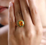 madeira citrine and chrome diopside oval halo ring in 10k yellow gold worn on a hand