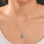 ceylon blue sapphire paraiba tourmaline and diamond oval halo pendant necklace in 950 platinum worn around the neck