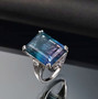 rainbow fluorite and moissanite emerald cut cocktail ring in rhodium over sterling silver shown in a lifestyle photo
