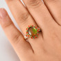 ammolite fire opal diopside and zircon halo ring in 18k yellow gold over sterling silver worn on a hand