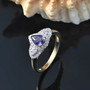 purple sapphire and diamond pear halo ring in 10k yellow gold shown in a lifestyle photo