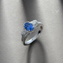 ceylon blue sapphire and diamond ring with padparadscha accents in 10k white gold shown in a lifestyle photo