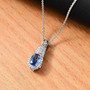 ceylon blue sapphire and diamond pendant necklace with padparadscha accents in 10k white gold shown in a lifestyle photo
