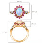 ethiopian opal pink sapphire and moissanite oval halo infinity shank ring in 18k yellow gold over sterling silver shown for size comparison