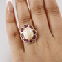 ethiopian opal rhodolite garnet and white zircon halo ring in 18k yellow gold over sterling silver worn on a hand