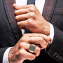 black diamond and white diamond gents ring in 10k yellow gold worn on a hand