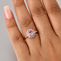 kunzite pink sapphire and moissanite oval double halo ring in 18k rose gold over sterling silver worn on a hand
