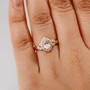 morganite and white zircon halo ring in 18k rose gold over sterling silver worn on a hand