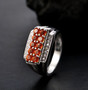 fire opal and zircon gents ring in rhodium over sterling silver shown in a lifestyle photo
