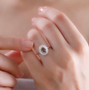 andalusite and moissanite halo ring in rhodium over sterling silver worn on a hand