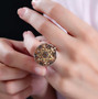 andalusite and white zircon cluster star ring in rhodium over sterling silver worn on a hand
