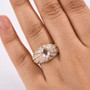 morganite and moissanite ring in 18k rose gold over sterling silver worn on a hand