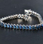 blue star sapphire tennis bracelet in rhodium over sterling silver shown in a lifestyle photo