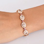 morganite rubellite and moissanite bracelet in 18k rose gold over sterling silver worn on a wrist