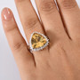 trillion yellow labradorite and moissanite halo ring in rhodium over sterling silver worn on a hand