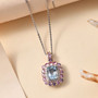 aquamarine pink sapphire and zircon halo pendant necklace in 18k rose gold and rhodium over sterling silver shown in a lifestyle photo